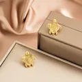 Elegant golden turtle-shaped stainless steel stud earrings displayed on jewelry boxes - Spiral Texture Turtle Style (E1400-A) / 1 Pair Pack / Gold