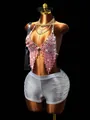 Macro detail of a pink crystal fringe body chain paired with silver metallic rave shorts. - One Size / Light Pink