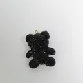 Macro view of a sparkling black rhinestone bear charm with a gold attachment loop - Zircon Bear / Black