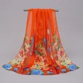 Detail of an orange chiffon scarf featuring vibrant floral and peacock feather prints. - Orange Peacock Feather Floral Style (26#) / 50x150cm