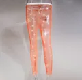 Close-up detail of sexy orange mesh trousers with sparkly rhinestones for women - One Size / Extra Long Bottom / Neon Orange
