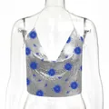 Dettaglio di top all'americana in paillettes d'argento con motivi blu di sole e occhi. - Stampa Sole