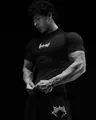 Muscular athlete in black Breathedivinity compression fitness tee and shorts detail view - S / Tops / Black