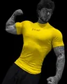 Detail view of yellow compression gym t-shirt featuring Breathe Divinity logo on chest. - S / Tops / Yellow