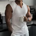 Detailed view of men's white ribbed muscle tank top featuring a V-neck in a gym lifestyle setting - 3XL / Tops / White