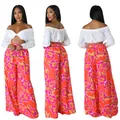 Zweiteiliges Set mit weißem schulterfreiem Crop-Top und oranger floraler Weithose - S / Unterteile / Rot