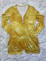 Close-up of yellow long sleeve romper with Scorpio constellation print and V-neck. - Scorpio