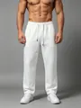 Detail of men's white loose-fit straight-leg sweatpants showing fabric texture and drape - S / Bottoms / White