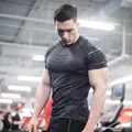 Detail of men's quick-dry compression gym t-shirt with geometric patterns - T121 Black