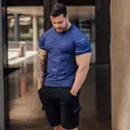 Muscular man wearing blue compression gym t-shirt with geometric pattern outdoors. - T121 Blue