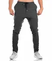 Detailed view of charcoal grey slim-fit athletic joggers for men on a fit model. - M / Bottom (With Logo) / Dark Gray