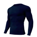 Angled view of dark navy long sleeve compression shirt showing the sleek athletic fit - M / Tops / Navy Blue