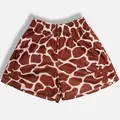 Detailed close-up of breathable brown and white giraffe print mesh sports shorts - S / Bottoms / Brown Yellow Cow Print