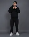 Model wearing a black 400G fleece tracksuit with hoodie and matching joggers. - S / Top And Bottom / Black