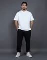 Detail view of 400G fleece black joggers worn by a male model against a gray background - S / Black