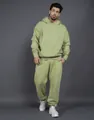 Male model showcasing a light green oversized fleece hoodie and sweatpants two-piece set - S / Top And Bottom / Fruit Green