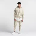 Professional studio view of men's solid beige slim fit joggers with matching hoodie - S / Top And Bottom / Khaki