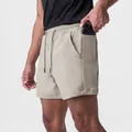Detailed view of khaki men's athletic shorts featuring a functional side phone pocket - S / Bottoms / Khaki