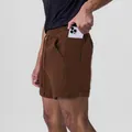 Close-up of men's brown athletic sports shorts with a functional side phone pocket - Coffee