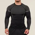 Close-up detail of men's compression long-sleeve gym shirt with grey mesh panels - S / Tops / Black and Gray