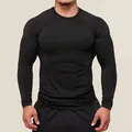 Detail shot of men's black compression long sleeve shirt for gym fitness training - S / Tops / Black