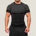 Close-up of men's quick-dry compression workout t-shirt with grey honeycomb pattern - S / Tops / Black and Gray