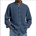 Close-up of blue waffle knit texture on men's casual button-down long-sleeve shirt - Navy Blue