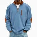 Detailed view of men's blue ribbed corduroy half-zip sweatshirt featuring brown elbow patches - Sky Blue