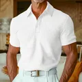 Detail view of a white waffle knit polo shirt showing texture and button placket - S / Tops / White