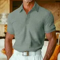 Detailed view of men's sage green waffle knit polo shirt showing rich fabric texture - Green