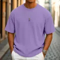 Detailed view of a men's lavender waffle knit t-shirt featuring a relaxed fit on a model. - S / Tops / Purple