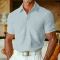 Close-up of men's light blue waffle-knit polo shirt with textured fabric and classic collar. - Light Green