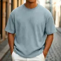 Close-up of men's casual light blue waffle knit T-shirt showing detailed ribbed texture - Light Blue
