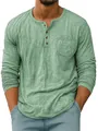 Close-up detail of men's green long sleeve Henley shirt with chest pocket and textured fabric - S / Tops / Green
