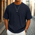 Close-up detail of a navy blue waffle knit short sleeve casual t-shirt for men outdoors - S / Tops / Navy Blue