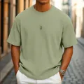 Close-up view of a men's sage green waffle knit short sleeve T-shirt with premium texture. - S / Tops / Green