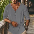 Close-up of grey textured long-sleeve V-neck shirt worn by model in beach setting - S / Tops / Gray
