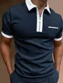 Close-up of navy blue polo shirt featuring a white contrast collar and zipper detail - S / Tops / Navy Blue