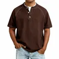 Detailed view of a men's brown vintage washed cotton Henley shirt with raglan sleeves. - Dark Brown