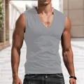 Detailed view of a men's slim fit grey V-neck tank top shown on an athletic model outdoors - S / Tops / Gray