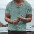 Close-up of men's slub cotton short sleeve T-shirt in sage green with textured finish - S / Tops / Green