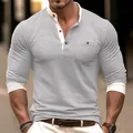 Close-up of a men's grey long-sleeved Henley shirt with white contrast collar detail - Gray