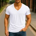 Close-up detail of a white V-neck short-sleeved T-shirt on a muscular male model outdoors. - S / Tops / White