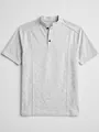 Detailed view of grey knit men's polo shirt with mandarin collar and black buttons - S / Tops / White