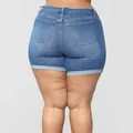Plus size high waist stretchy blue denim shorts with rolled hem cuffs shown from the back - L / Blue