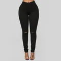 Vista dettagliata dei jeans skinny neri a vita alta elasticizzati da donna con strappi - Taglia S / Pantaloni e gonne / Nero