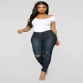 Detailed view of women's high stretch skinny jeans with knee rips in dark wash denim - S / Dark Blue
