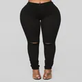 High waist black ripped skinny jeans for women featuring trendy knee cutouts and stretch fit - S / Black