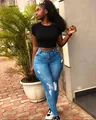 Casual outfit featuring high-waisted ripped blue jeans and a sleek black crop top - Light Blue