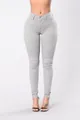 Detailed view of women's high-waisted stretchy skinny jeans in light grey - Gray